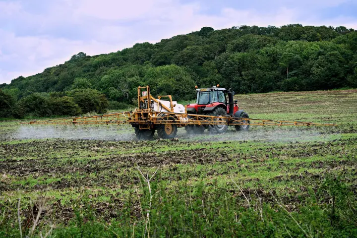 tractor sprayer working in the field