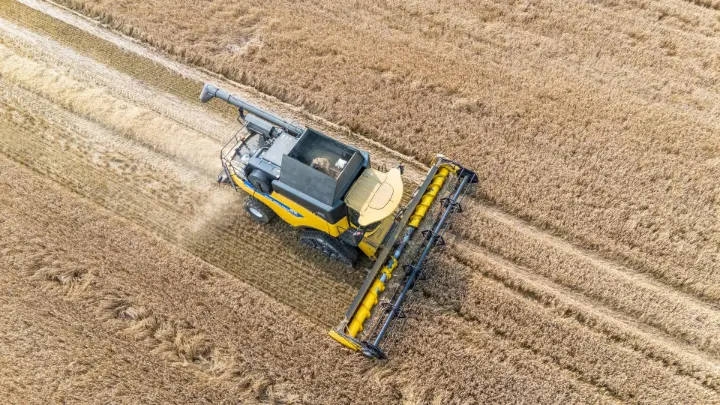 Tractor equipped with a GPS guidance system ensuring straight rows in a field.