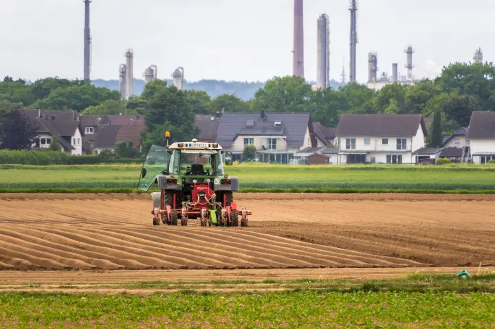 Tractor equipped with an affordable GPS auto steer system working on farmland.