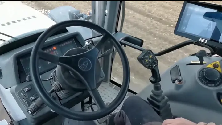 A modern tractor equipped with the FJD AT2 Auto Steer System operating in a field, ensuring precise row alignment.