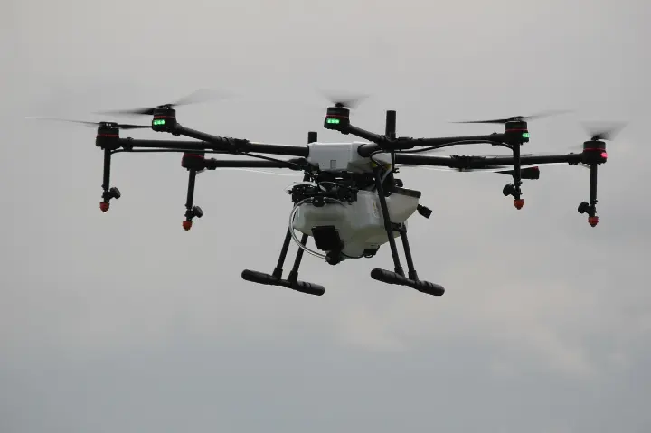 An agricultural drone scanning crops for real-time data analysis and yield optimization.