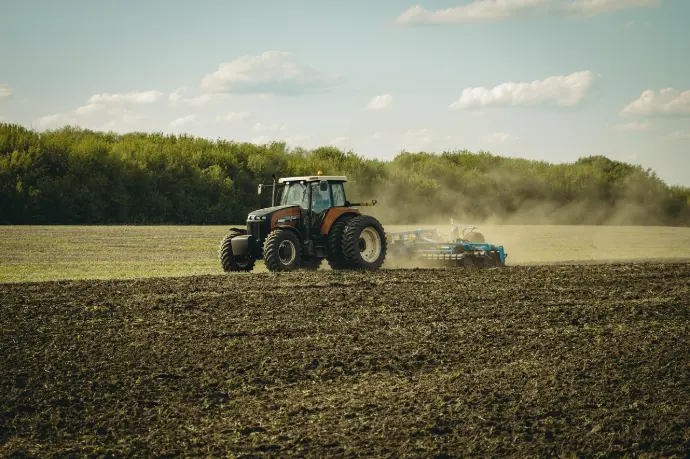 compact small tractor for farming plowing a field efficiently