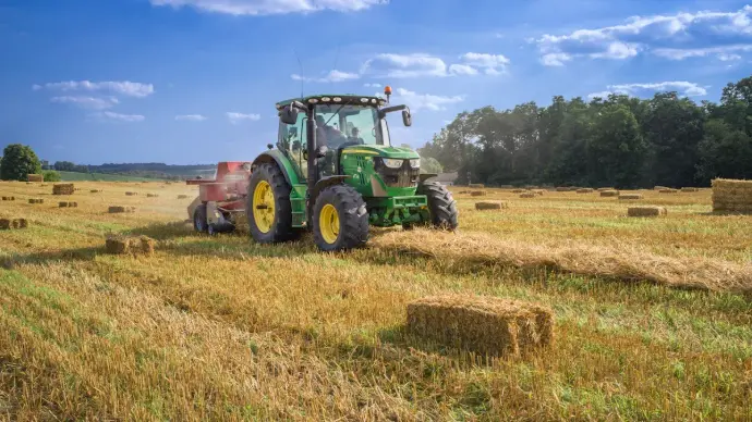 Modern tractor used in precision farming, pulling equipment for crop cultivation