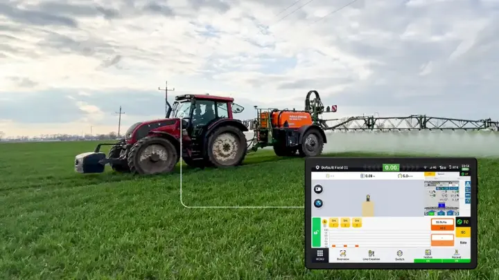 Tractor spraying field with precision agriculture technology