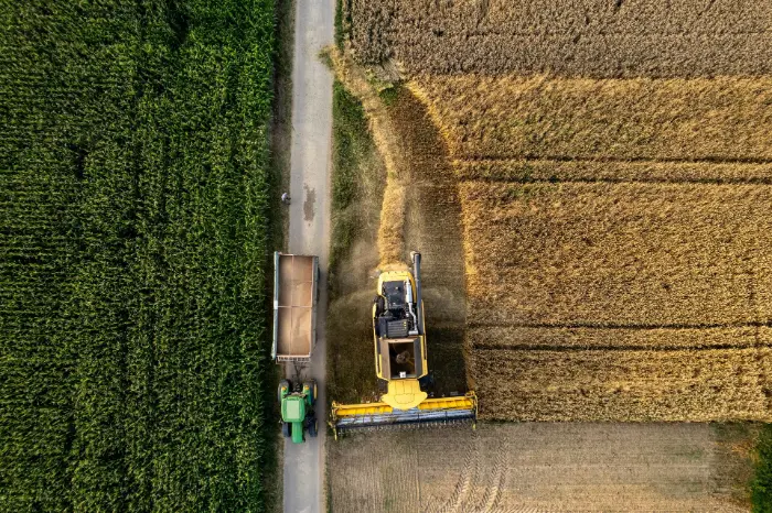 Aerial view of tractor harvesting wheat
