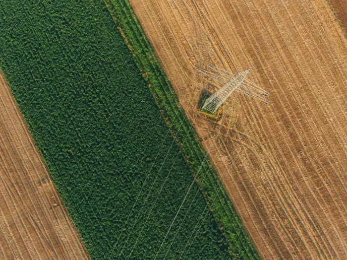 Aerial view of powerline crossing farmland