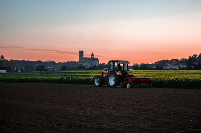 Tractor in the field in the sunset