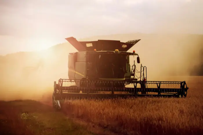A tractor harvesting in the field