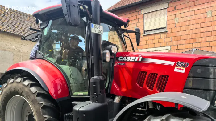 Red tractor with two people inside