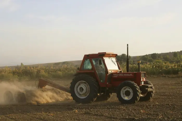 Tractor with plowing implement