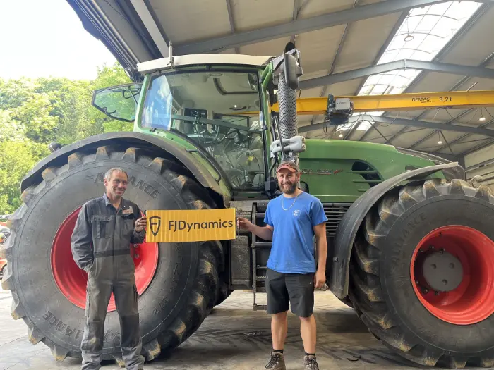 Two men with tractor and banner
