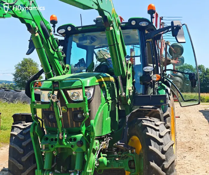 Green tractor in farm field scene
