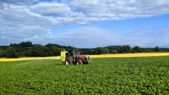 Tractor spraying crops in field