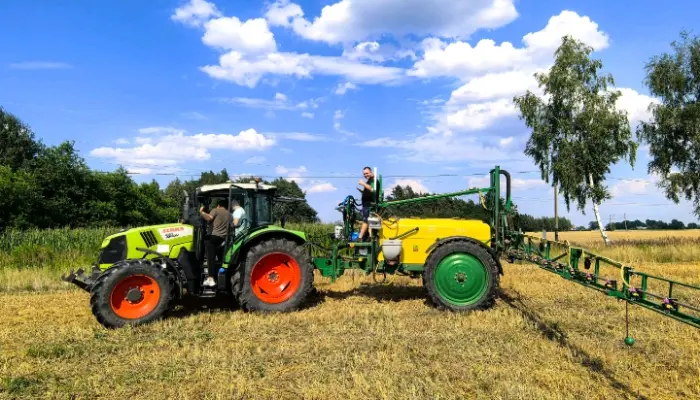 Tractor and sprayer in field