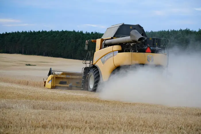 Harvester working in field