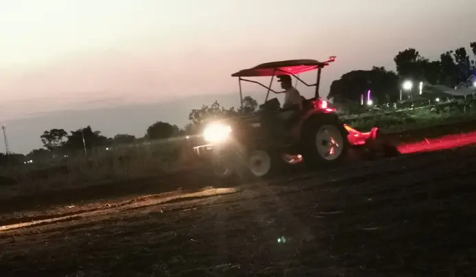 a smart tractor is working at night.
